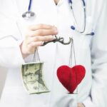 A doctor balances a $20 bill and a heart on a scale to show how understanding reference-based pricing works is crucial for saving money on healthcare coverage.