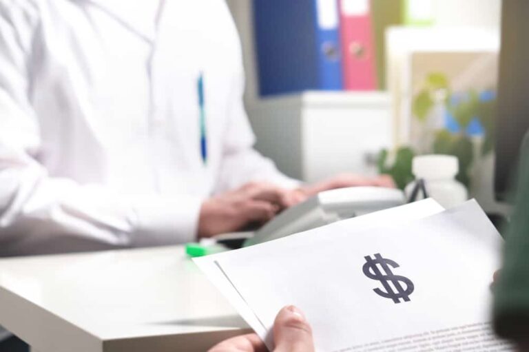 A patient reviews a medical bill with a giant dollar sign to illustrate the benefits of choosing RBP vs PPO
